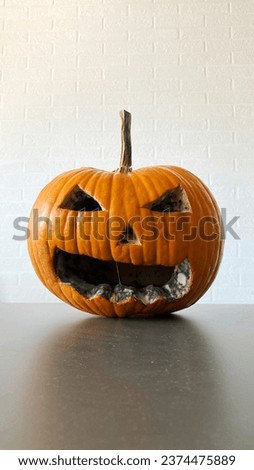 Scary rotten Halloween pumpkin. Jack-O-Lantern closeup with copy-space