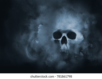Scary skull emerging from a cloud of smoke / high contrast image