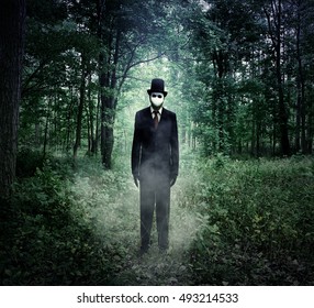 A Scary Tall Man In A Black Suit Is Standing In The Dark Woods At Night With Fog For An Evil Halloween Or Fear Concept.