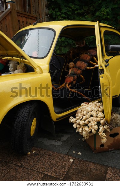 scary toy in the interior of a yellow car, photo\
for Halloween                 \
