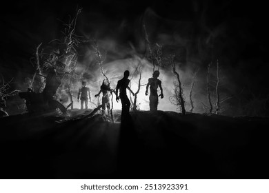 Scary view of zombies at cemetery dead tree, moon, church and spooky cloudy sky with fog, Horror Halloween concept. Selective focus