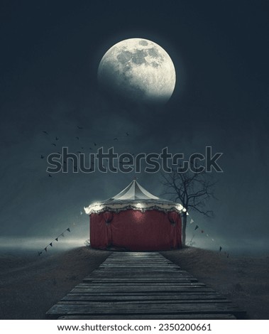 Scary vintage circus tent in the dark and big full moon