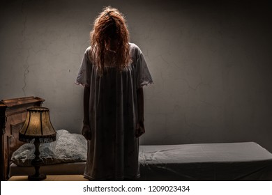Scary woman possessed by devil in the bed. Exorcism of priest.  - Shutterstock ID 1209023434