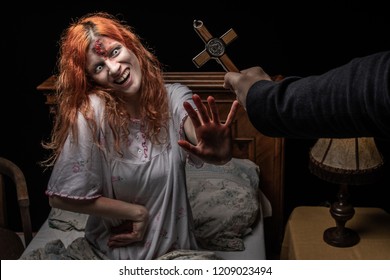 Scary woman possessed by devil in the bed. Exorcism of priest.  - Shutterstock ID 1209023494