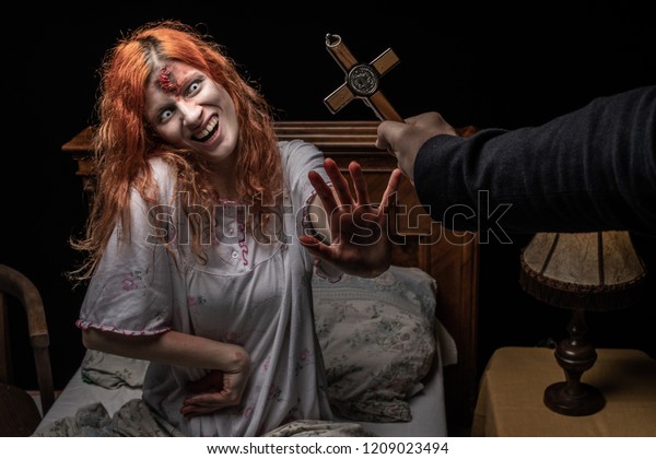 Scary woman possessed by devil in the bed. Exorcism of\
priest. 