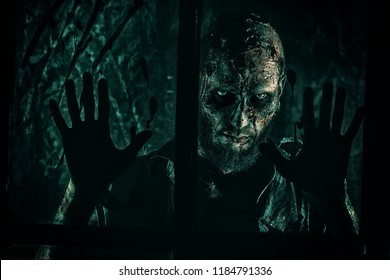 A Scary Zombie Standing Behind The Window. Halloween. Horror Movie.