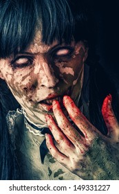 Scary zombie woman  with white eyes and bloody hand