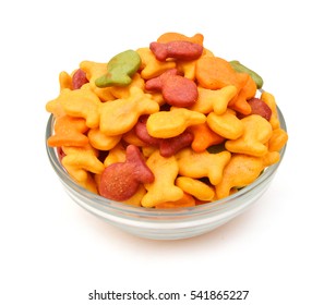 A Scaterring Of Yellow Goldfish Crackers In Glass Bowl On White Background 