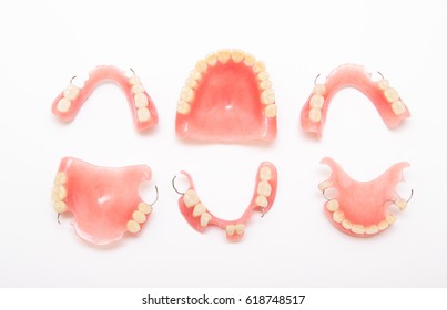 Scattered Acrylic Dentures Isolated On White Background Seen From Above.  Copy Space. 