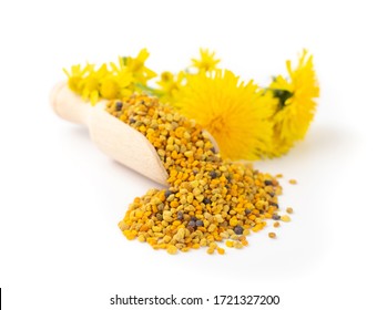 Scattered Bee Pollen Or Perga Isolated On White Background. Raw Brown, Yellow, Orange And Blue Flower Pollen Grains Or Bee Bread In Wooden Scoop. Healthy Food Supplement