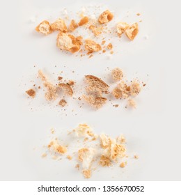 Scattered bread crumbs on white background, top view