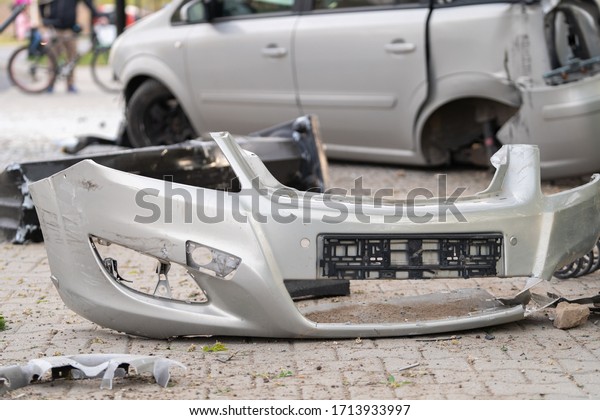 Scattered car parts after the accident. Car
crash accident on street. Road incident car crash on a street.
Damaged automobiles after collision in city. Traffic accident and
insurance concept.