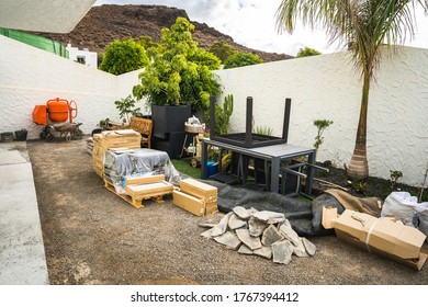 Scattered Construction Site Materials And Tools In Backyard. Construction Work Beginning Early Stage Ready For Garden Backyard Renovation