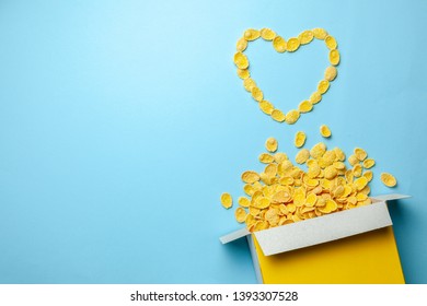 Scattered cornflakes out of box a heart shaped. Dry cereal breakfast. I love cereal. Copy space for text
