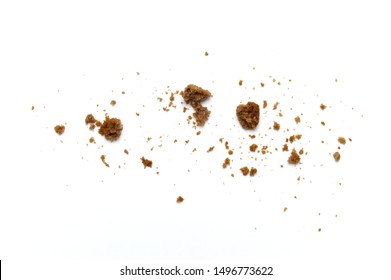 Scattered crumbs of chocolate chip butter cookies on white background.