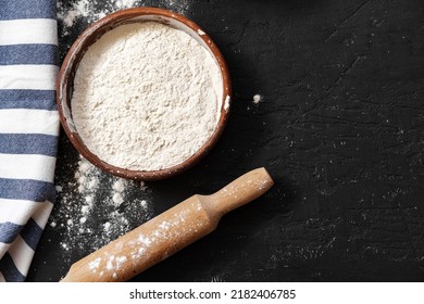 Scattered Flour With Rolling Pin On Black Background Top View