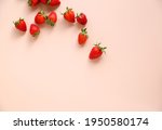 Scattered fresh strawberries on a pink background. Free space.