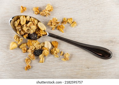 Scattered Muesli, Granola In Metallic Spoon On Wooden Table. Top View