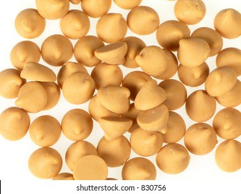 Scattered Pile Of Butterscotch Chips Over White