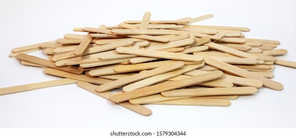 Scattered Pile Of Wooden Brown Popsicle Sticks.