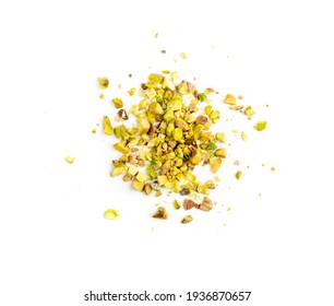 Scattered pistachio nut pieces isolated. Break chopped pistachios pile, fried baked diced pistache on white background top view