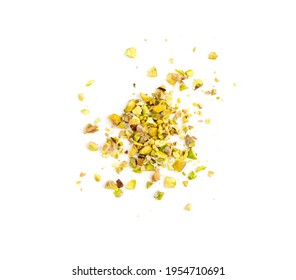 Scattered pistachio nut pieces isolated. Break chopped pistachios pile, fried baked diced pistache on white background top view