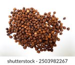 Scattered Raw Black Chickpeas (Garbanzo, Kala or Kabuli Chana) scattered on white background, showcasing healthy food, nutrition, vegan cuisine. Cicer arietinum.