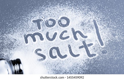 Scattered Salt On The Table With The Words Too Much Salt!