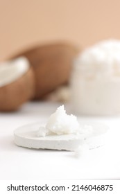 Scattered Scrub With Jar With Coconut On White And Brown Background. Home Spa Treatment Concept, Organic Cosmetic. Vertical Photo.