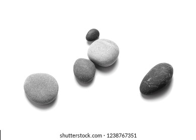 Scattered sea pebbles. Smooth gray and black stones isolated on white background. Top view - Shutterstock ID 1238767351