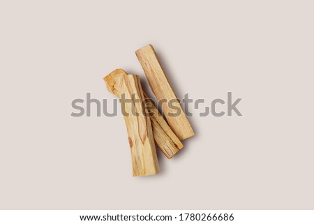 Scattered sticks of Palo Santo tree on a light background. Top view. Organic holy tree incense from Latin America. Color photo close-up of natural frankincense.