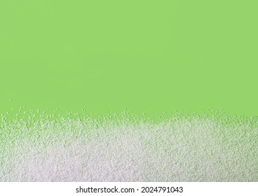 Scattered sweetener without calories on a green background. Copy space