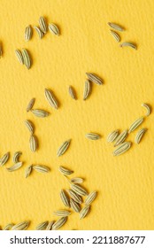 Scattering Green Fennel Seeds On Yellow Textural Background. Traditional Aromatic Seasoning And Ingredient Of Ayurvedic Food