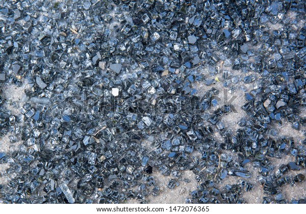 A\
scattering of pieces of broken automobile glass lies on the\
asphalt. After the accident. Background\
image.