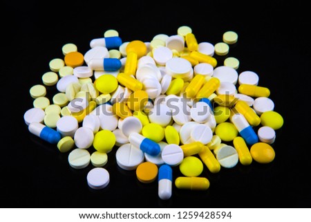 Scattering Pills on the Black Background closeup