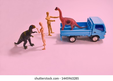   A scene from above looking down on a dinosaur model from a truck for an outdoor performance.                             