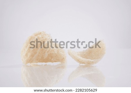 Scene for advertising product from natural origin with raw edible bird’s nest isolated on white background. Bird’s nest is one of important supplements for longevity and youth.