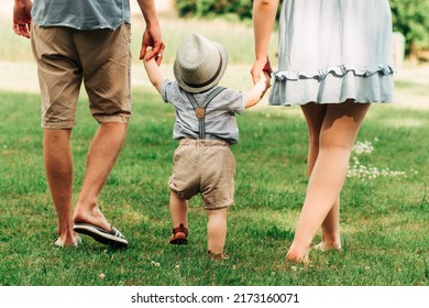 Scene From Behind Of Happy Family Spend Time Together Walking And Relaxing At The Park In The Afternoon Summer, Concept Family Togetherness, Warm Hearted Family, Parenthood, Happy Family Outing. 