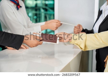 Scene of boarding pass checking by air ground staff and passengers at airport gate for travel with airplane service.