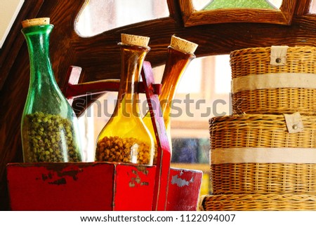 A Scene with Bottles and Baskets infront of a window.