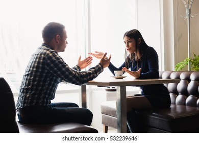 Scene in cafe - couple conflict arguing during the lunch.