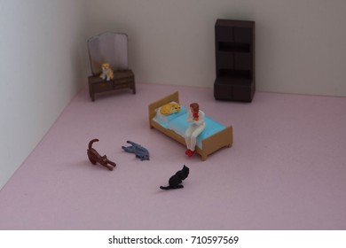 Scene Created With Miniature Toy People. Stereotype Of The Lonely Or Crazy Cat Woman. Lady With Many Cats In Her Apartment Or House. How Many Cats Is Too Many Cats?