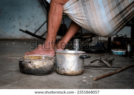 scene of extreme poverty, candles and old pots on the floor, person lying on the hammock, legs, beaten floor, old sandals, slippers, stick, dirty house, everyday life

