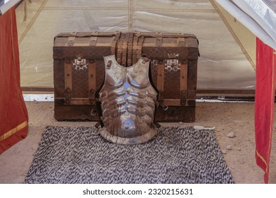 scene in horizontal view of an old trunk and ancient roman soldier armor cuirass 