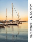 Scene of leisure yacht sailboats docked at small harbour in Cape Town at sunset