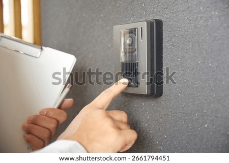 The scene of a man in work clothes visiting a house