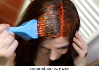 Scene In Motion. Process Of Hair Coloring At Home. Applying Red Color To Your Hair.