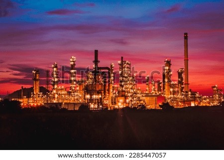 Scene of the oil refinery plant of petrochemistry Oil​ refinery​ and​ plant and flue smoke industry in oil​ and​ gas​ ​industry with​ cloud​ red and orange ​sky the morning​ background​