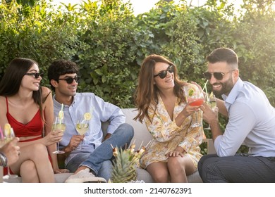 Scene Of People Smiling, Drinking Cokctails And Toasting Happily, Elegant Party Outdoors Of A Small Business Agency Teamwork