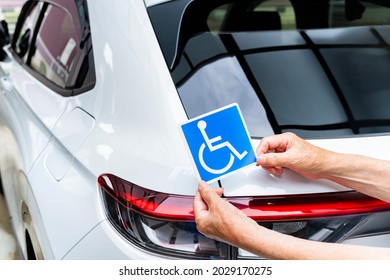 Scene of putting a wheelchair mark on a car